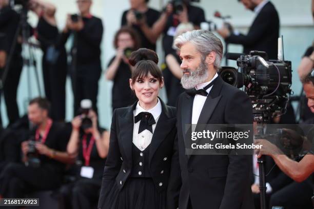 Winona Ryder and Scott Mackinlay Hahn attend the red carpet for "Beetlejuice Beetlejuice" during the 81st Venice International Film Festival at...