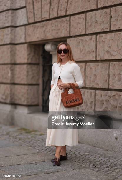 Sonia Lyson seen wearing Loewe brown sunglasses, Zara creamy white cotton buttoned cardigan, matching Zara creamy white long pleated skirt, Loewe...