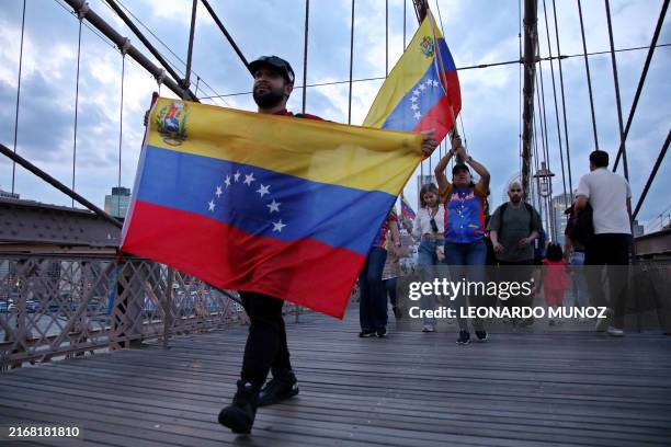 People hold Venezuelan flags during a protest against Venezuelan President Nicolas Maduro and the results of the recent presidential election on the...