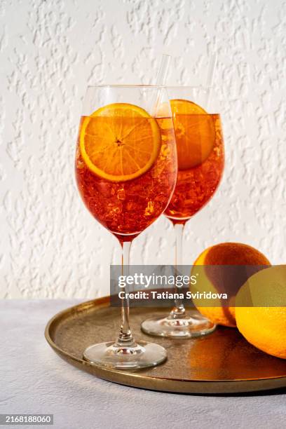 cocktail or mocktail, two glasses with orange garnish, spritz - aperol spritz stock pictures, royalty-free photos & images