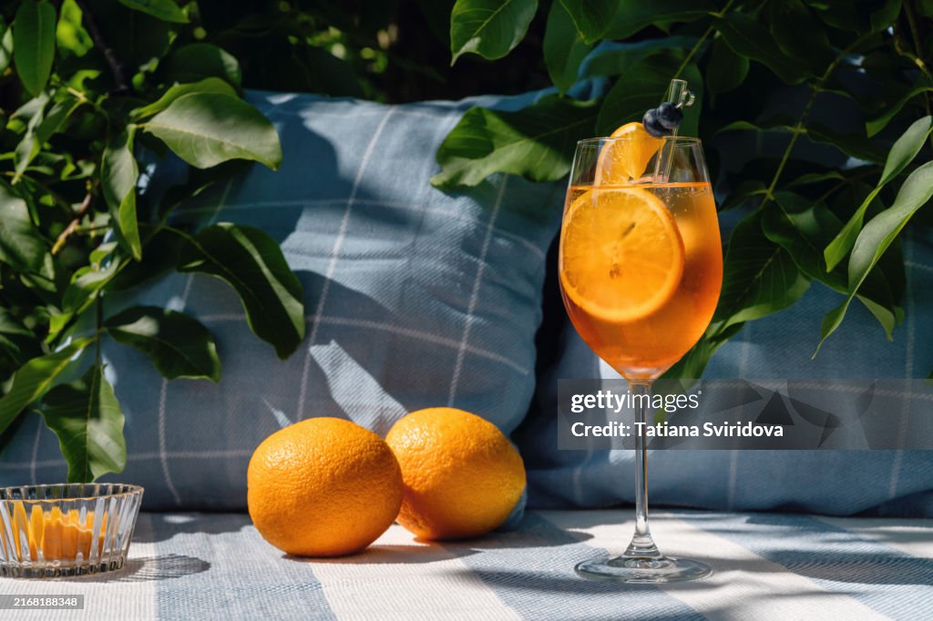 Cocktail or mocktail, glass with orange garnish, Spritz