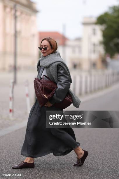 Sonia Lyson seen wearing Dior black triangle shaped sunglasses, The Frankie Shop black / dark grey short leather bomber jacket, By Aylin Koenig grey...