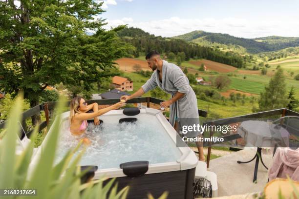 couple enjoying outdoor hot tub - hot tub stock pictures, royalty-free photos & images