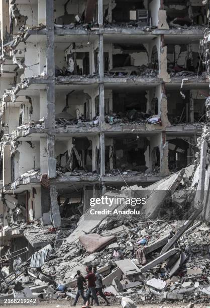 Palestinians remove whatever belongings they can salvage from the area as the devastation left by the Israeli army's withdrawal comes to light in...