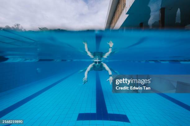 split screen asian chinese woman swimming in swimming pool. professional athlete gracefully finished her lap - half full stock pictures, royalty-free photos & images