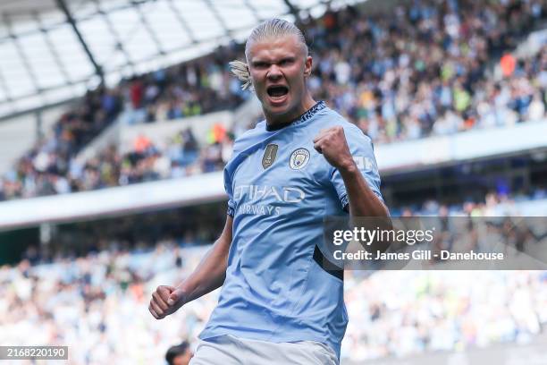 Erling Haaland of Manchester City celebrates after scoring his side's first goal from the penalty spot during the Premier League match between...