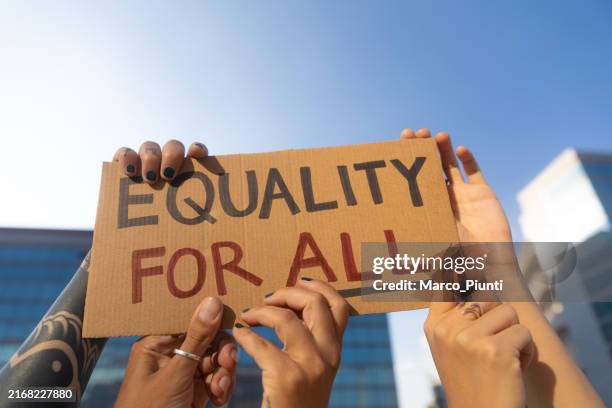 hands holding equality for all sign cardboard - civil rights stock pictures, royalty-free photos & images