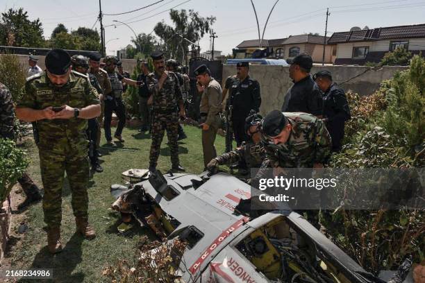 Iraqi security forces check the debris of a Turkish drone that the military said it downed over Kirkuk, on August 29 as Ankara kept up its operations...