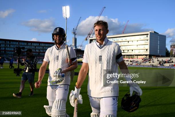 Chris Woakes and Joe Root of England celebrate winning the 1st Test Match between England and Sri Lanka at Emirates Old Trafford on August 24, 2024...