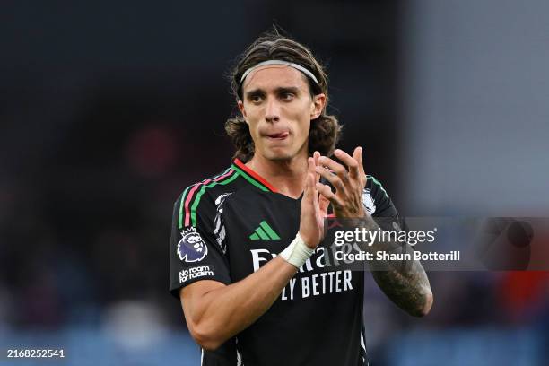 Riccardo Calafiori of Arsenal acknowledges the fans after the teams victory over Aston Villa in the Premier League match between Aston Villa FC and...