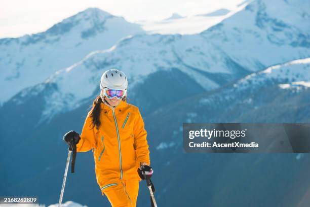 portrait of young woman skier on mountain top - whistler mountain stockfoto's en -beelden