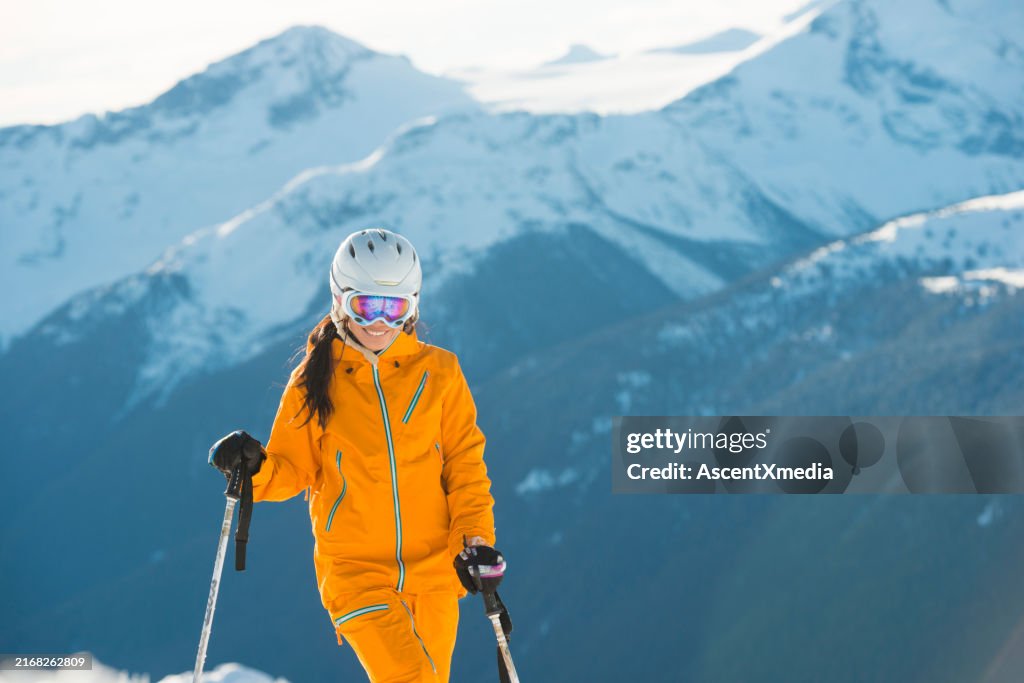 Portrait of young woman skier on mountain top