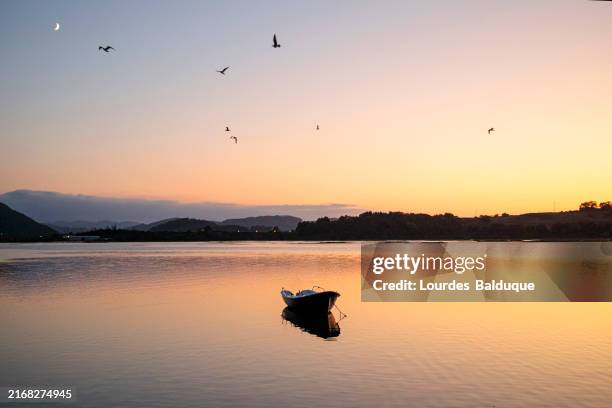 lone ship at lake at sunset - cantabria stock pictures, royalty-free photos & images