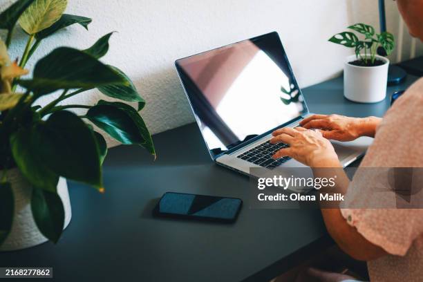 woman working at home office, hands on keyboard close up - old monitor computer stock-fotos und bilder