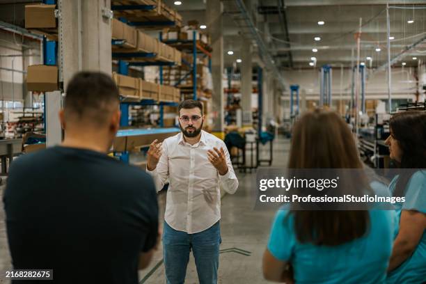 textile production plant manager discusses operations with staff - best art direction stock pictures, royalty-free photos & images