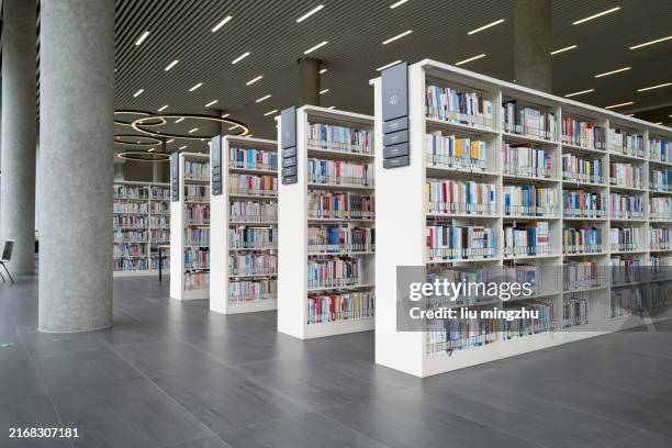 the bookshelf in the library is filled with bookshelves - sala de arquivos imagens e fotografias de stock