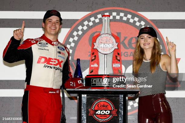 Harrison Burton, driver of the DEX Imaging Ford, and fiancee, Jenna Petty celebrate in victory lane after winning the NASCAR Cup Series Coke Zero...