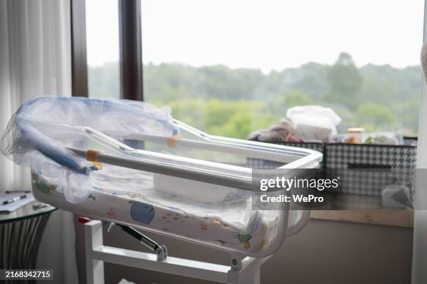 empty crib by the window, stroller - cot stock pictures, royalty-free photos & images