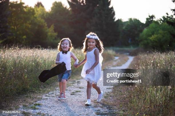 happy little bride and groom running together - veil stock pictures, royalty-free photos & images