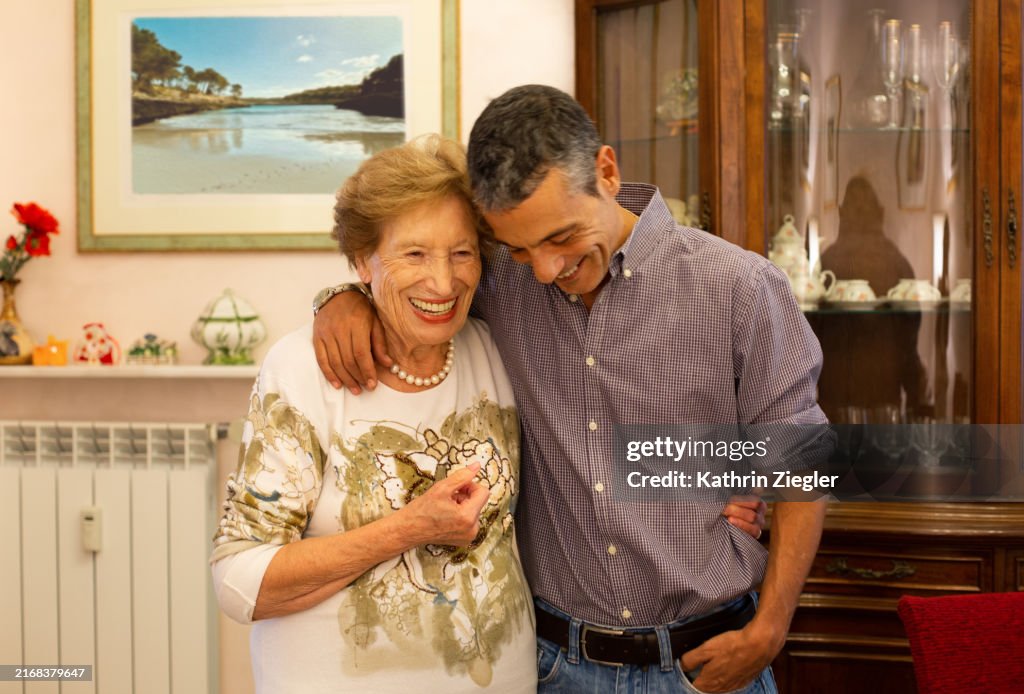 Elderly woman and her nephew embracing