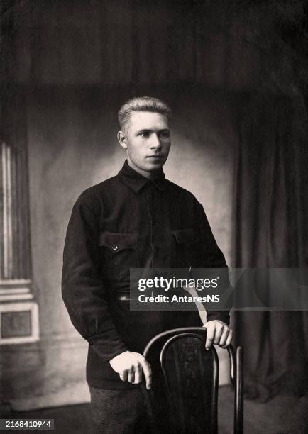 Vintage photo of a young man in typical clothing in the USSR in the 1930s. Photo from 1937