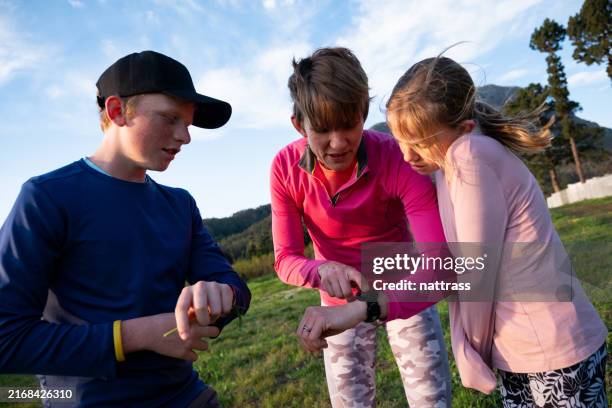 checking our sports watches after our jog together - checking the time stock pictures, royalty-free photos & images