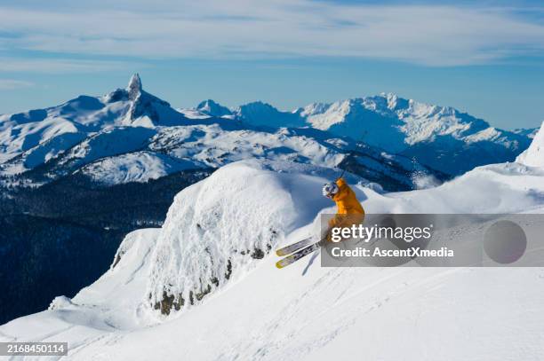 man skis steep slope at ski resort - professional skier stock pictures, royalty-free photos & images