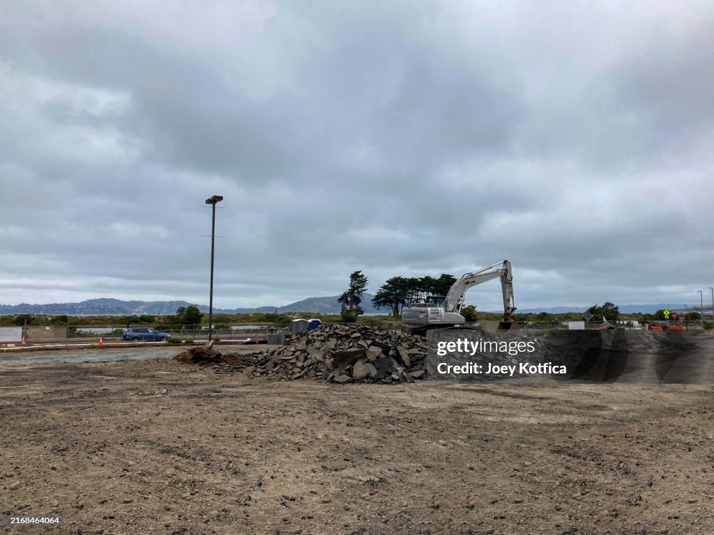 Backhoe construction vehicle on top of rubble