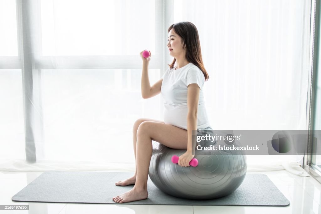 Pregnant woman doing exercises on a fitness ball