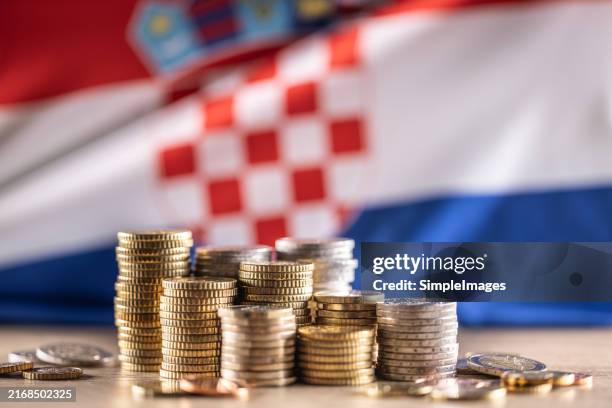 euro coins stacked on top of each other in different positions in front of the croatian flag. finance business and economy concept. - slovakia stock pictures, royalty-free photos & images