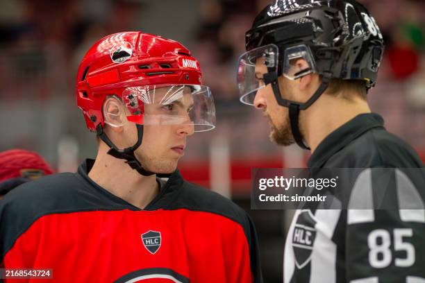 intense face-off between hockey player and referee - nhl emotion stock pictures, royalty-free photos & images
