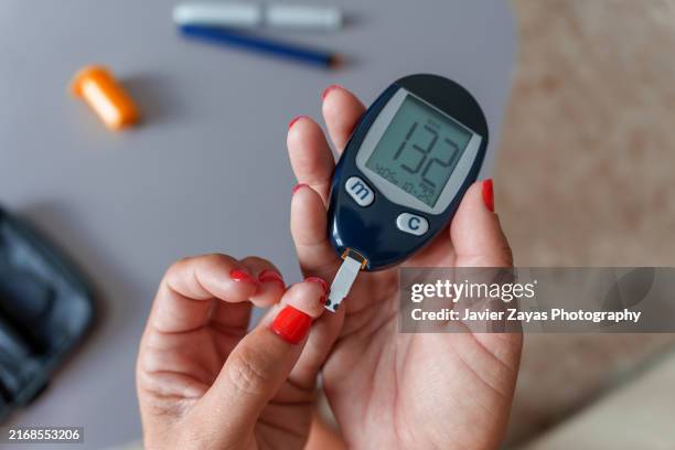 diabetic woman routine at home - blood sugar test stock pictures, royalty-free photos & images