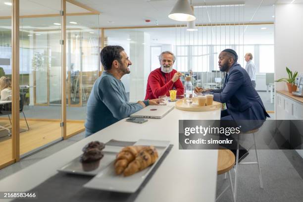 businessmen talking with each other - office snacks stock pictures, royalty-free photos & images