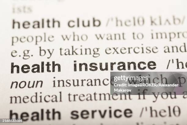 health insurance, text in dictionary. macro shot. selective focus - medical dictionary stock illustrations