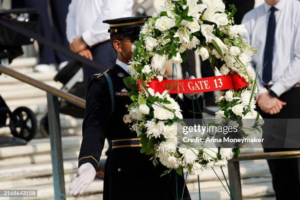 Military office carries a wreath for an army wreath laying ceremony to honor the lives of the American soldiers who died in Abbey Gate Bombing at the...