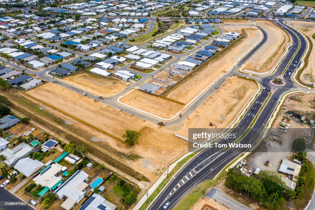 Aerial view of Smithfield Cairns construction site revealing new road development and adjacent residential areas