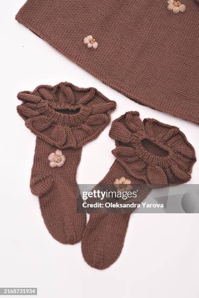 children's knitted clothes. children's room, nursery - hanger shoes stock pictures, royalty-free photos & images