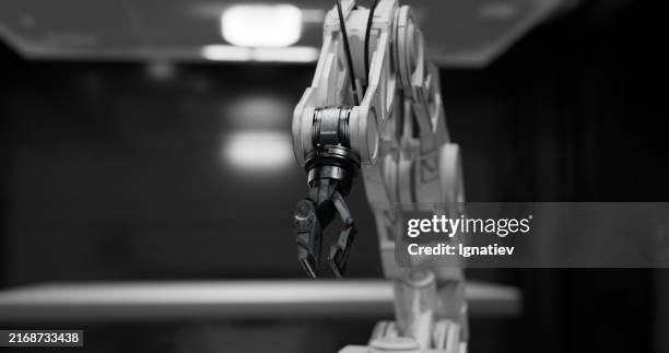 a detailed view of the robot’s mechanical arm, featuring a combination of light gray and dark tones - robotics stock pictures, royalty-free photos & images