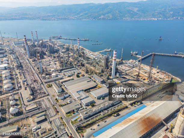 network of industrial buildings, storage tanks, pipelines, and chimneys. aerial view. - industrial district stock pictures, royalty-free photos & images