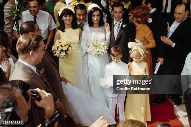 American comedian Danny Thomas looking over his daughters' shoulders following the wedding ceremony of Theresa Thomas and publicist Larry Gordon in...
