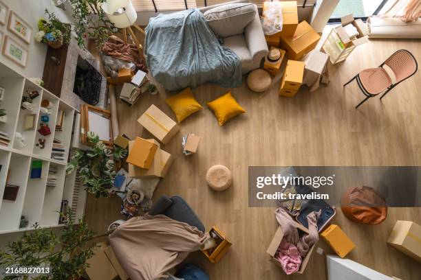 home moving background a room full of packing boxes furniture and interior decorate suff ready for unpacking in a new home - belongings stock pictures, royalty-free photos & images