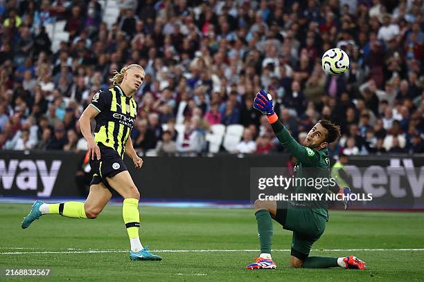 Manchester City's Norwegian striker Erling Haaland scores his third goal past West Ham United's Polish goalkeeper Lukasz Fabianski during the English...