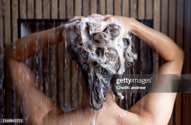 woman washing her hair with shampoo in the shower - shampoo stock pictures, royalty-free photos & images
