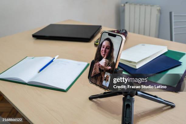 mobile phone screen of teacher speaking in sign language with student on a video call at remote lesson - zoom classroom stock pictures, royalty-free photos & images