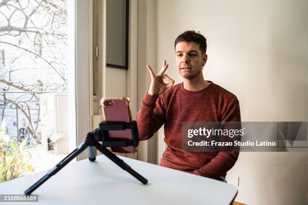 teacher speaking in sign language with student on a video call at remote lesson - deafness stock pictures, royalty-free photos & images