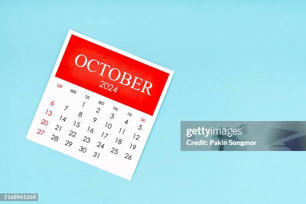october 2024 calendar is used to plan daily work and life on a blue color background. - october stock pictures, royalty-free photos & images