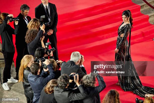 female celebrity posing for pictures on red carpet - red carpet stock pictures, royalty-free photos & images