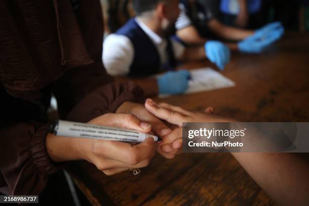 Health worker marks the finger of a Palestinian child vaccinated against polio in Deir Al-Balah in the central Gaza Strip, on September 1 amid the...