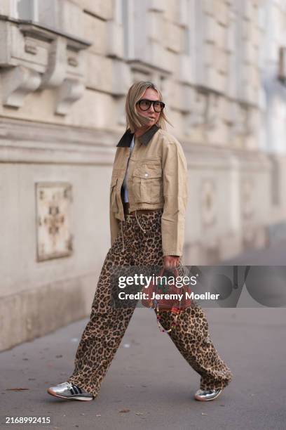 Karin Teigl seen wearing Andy Wolf black sunglasses, By Aylin Koenig white cotton basic cropped shirt, Bershka brown animal printed oversized long...