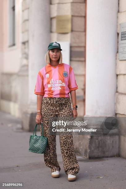 Karin Teigl seen wearing Aimee Leon Dore green logo printed cap, Pompeii pink / orange striped "Ibiza" print pattern trikot / jersey shirt, Bershka...